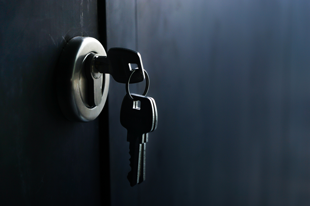 three keys with one engaged on a lock